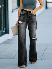 Black wide-leg distressed denim jeans with high rise and ripped details