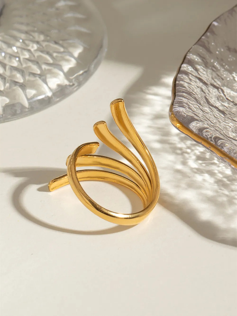 Sculptural spiral ring in gold, 18K gold-plated, with a unique layered band design.