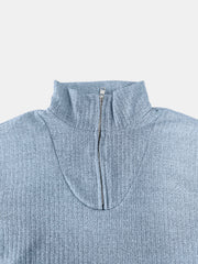 Light blue ribbed knit quarter-zip pullover sweater with a mock neck and silver zipper.
