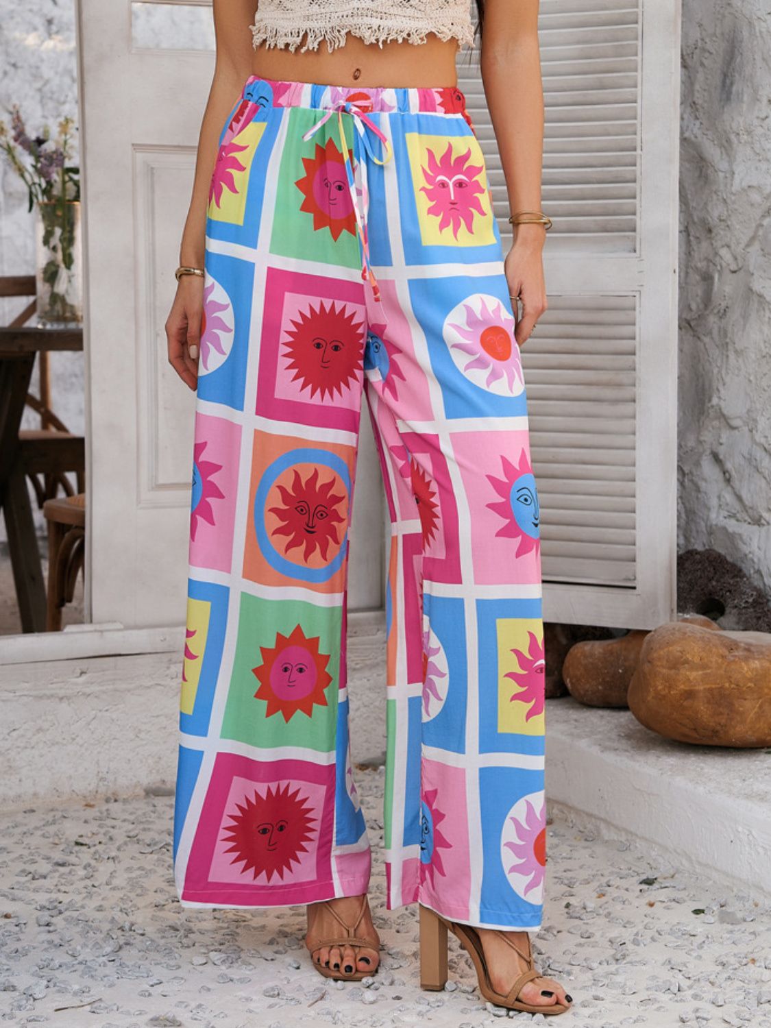 Geometric print wide-leg trousers with drawstring in multicolor sun pattern.