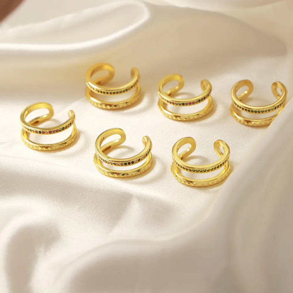 Double band pavé rings with multicolor stones and textured detail.