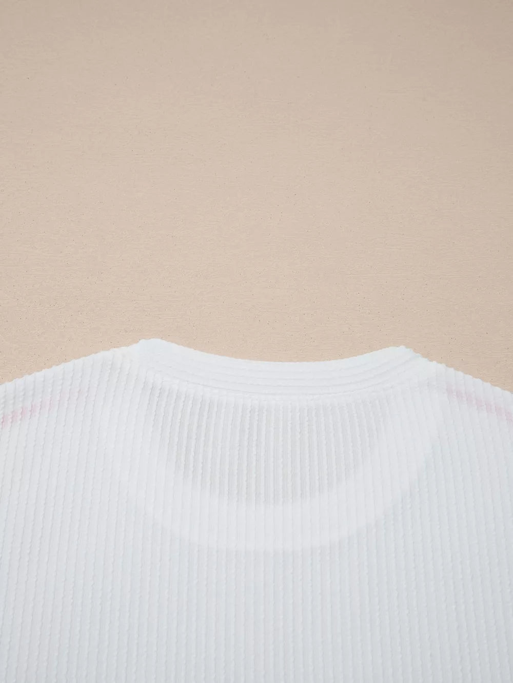 White ribbed maternity t-shirt with subtle contrast stitching detail on the neckline.