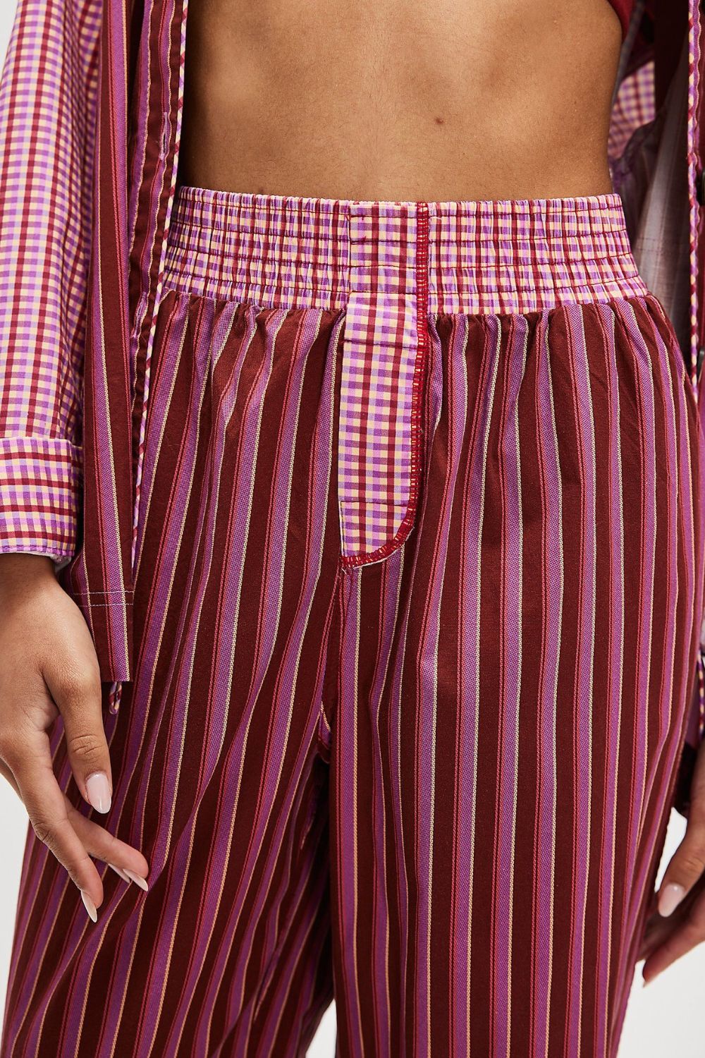 Crimson stripe palazzo trousers with a deep purple gingham waistband and red trim.