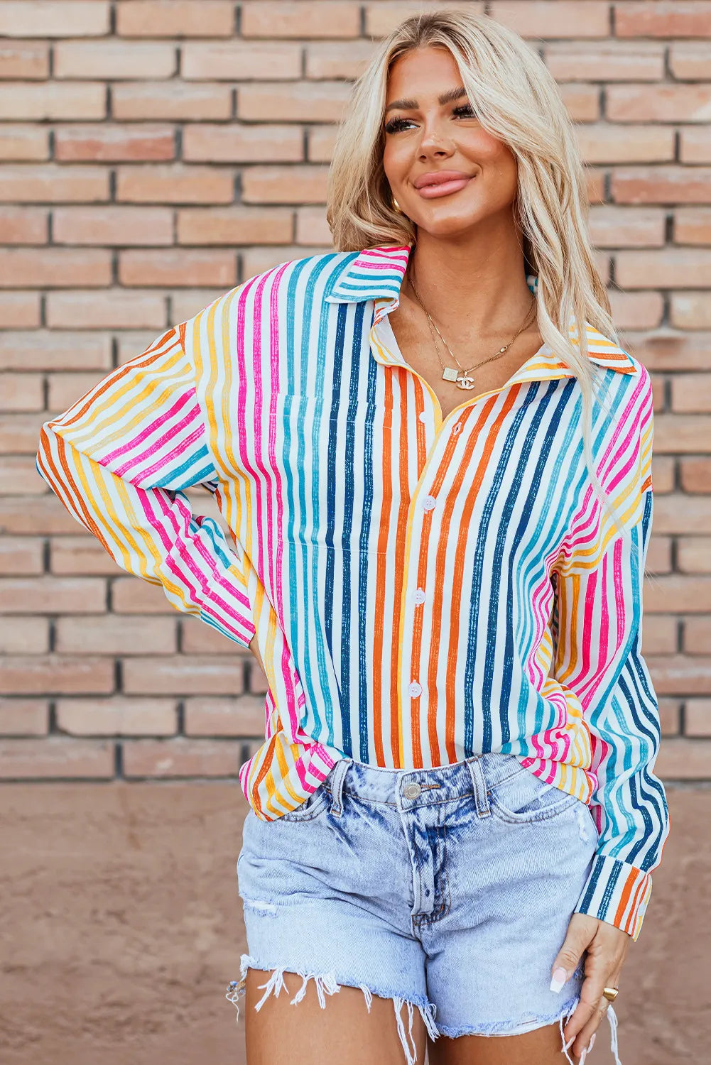 Rainbow stripe relaxed button-down shirt with a pocket and collared neckline.