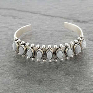 Open bangle bracelet with light gray cabochons and silver bead accents