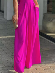 Hot Pink cinched waist wide leg romper with pockets and deep V-neck.