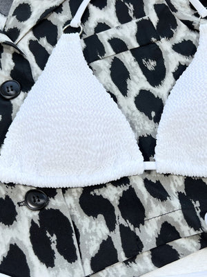 White textured bikini top with ring detail, shown with leopard print jacket.