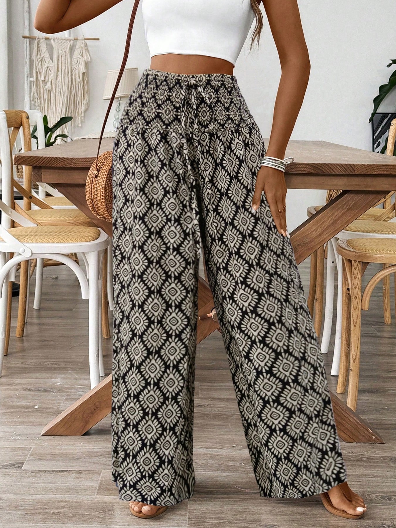 Geometric print wide leg pants with drawstring waist and black and cream pattern.