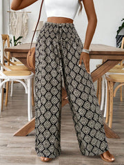 Geometric print wide leg pants with drawstring waist and black and cream pattern.