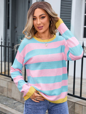 Striped knit sweater in blush pink, sherbet, and caramel with ribbed cuffs.