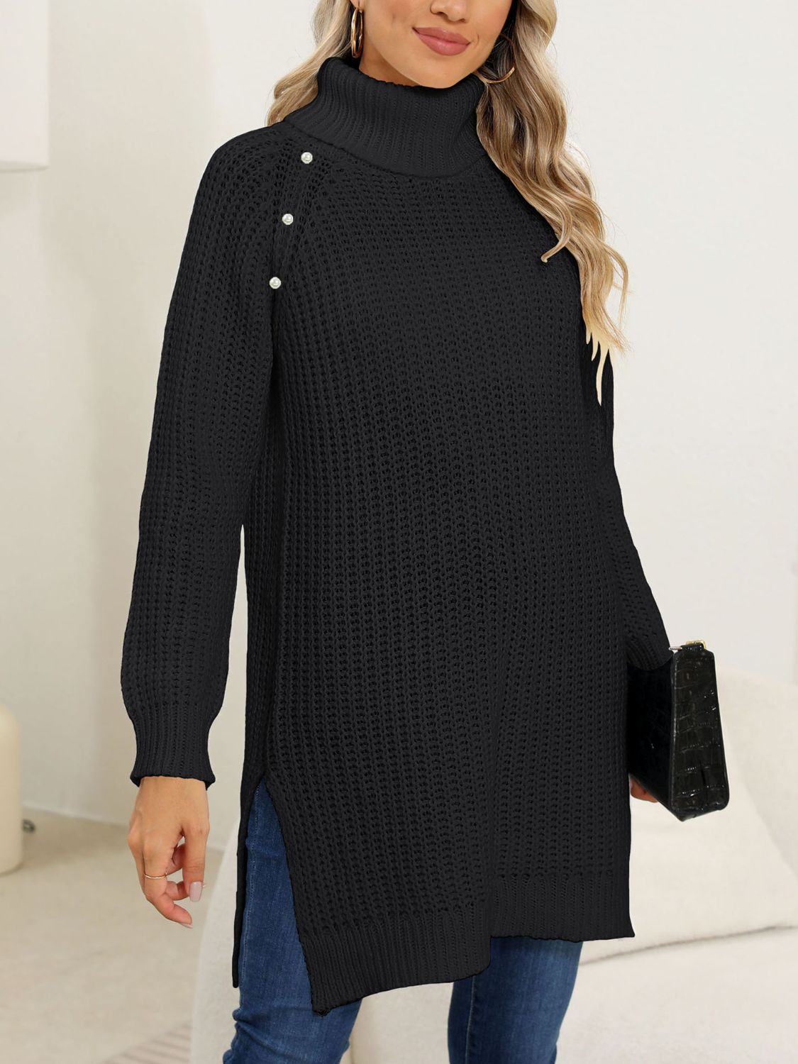 Black ribbed turtleneck tunic with pearl button detail on shoulder, side slits