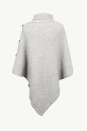 Light gray acrylic turtleneck knit poncho with button details on the shoulder.