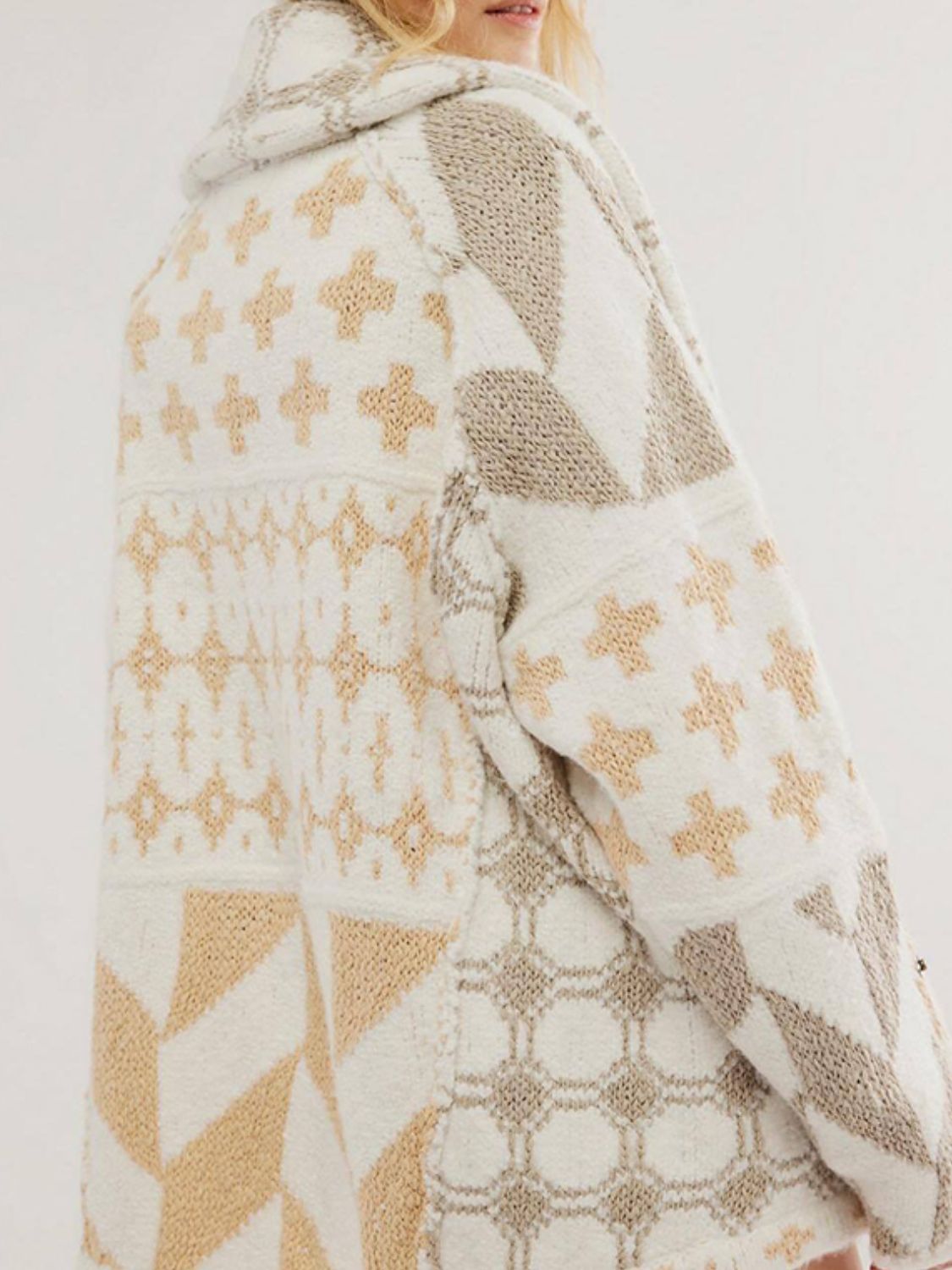 Geometric patchwork knit cardigan in cream and tan with a hooded neckline.