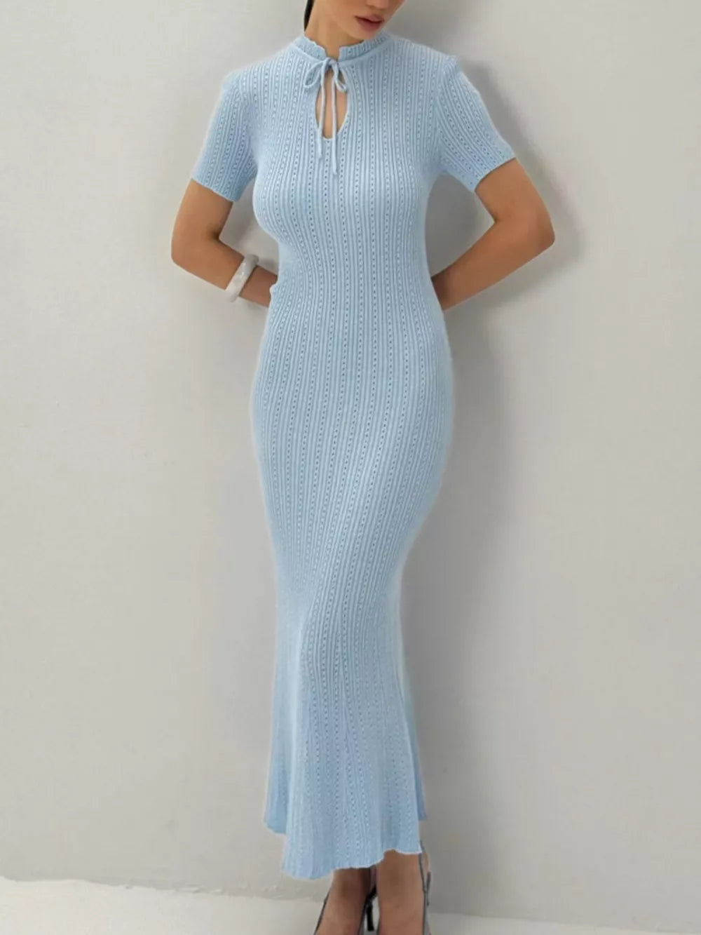 Light blue knitted mermaid dress with short sleeves and tied neckline detail.