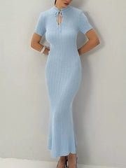 Light blue knitted mermaid dress with short sleeves and tied neckline detail.