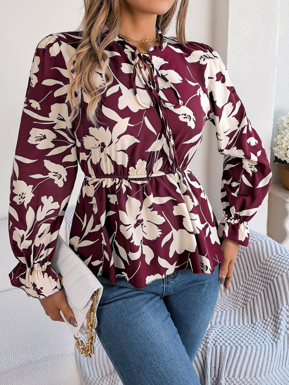 Burgundy floral peplum blouse with ruffled neck and tie detail