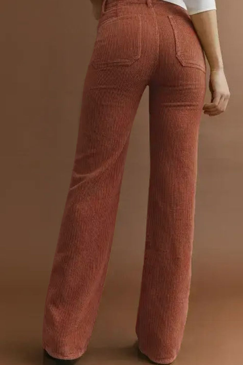Brown corduroy flared leg trousers with back pockets.