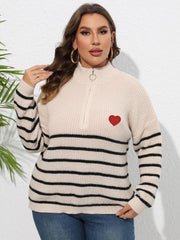Beige striped ribbed knit sweater with quarter zip and red heart appliqué.
