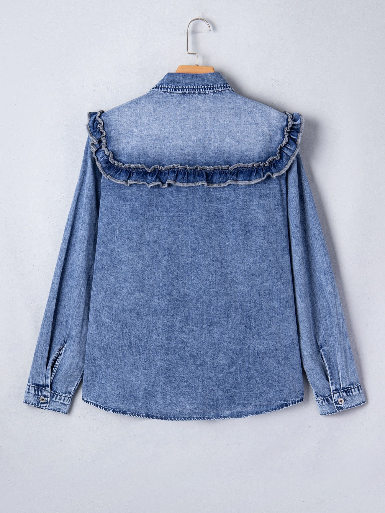 Denim ruffle button-down shirt with vintage wash and long sleeves.