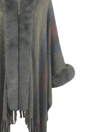 Textured stripe poncho with faux fur trim and cuffs, featuring fringe detail.