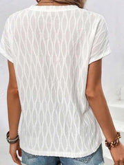 White textured tee with short sleeves and a subtle wave pattern.