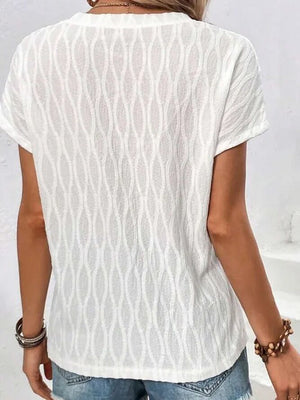 White textured tee with short sleeves and a subtle wave pattern.