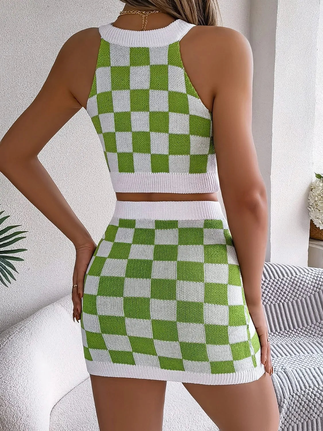 Green and white checkerboard knit halter crop top and mini skirt set with white trim.