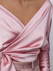 Blush pink satin blouse with draped detail and brooch accent