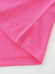 Bright pink cotton toddler t-shirt showing seam details and hem.