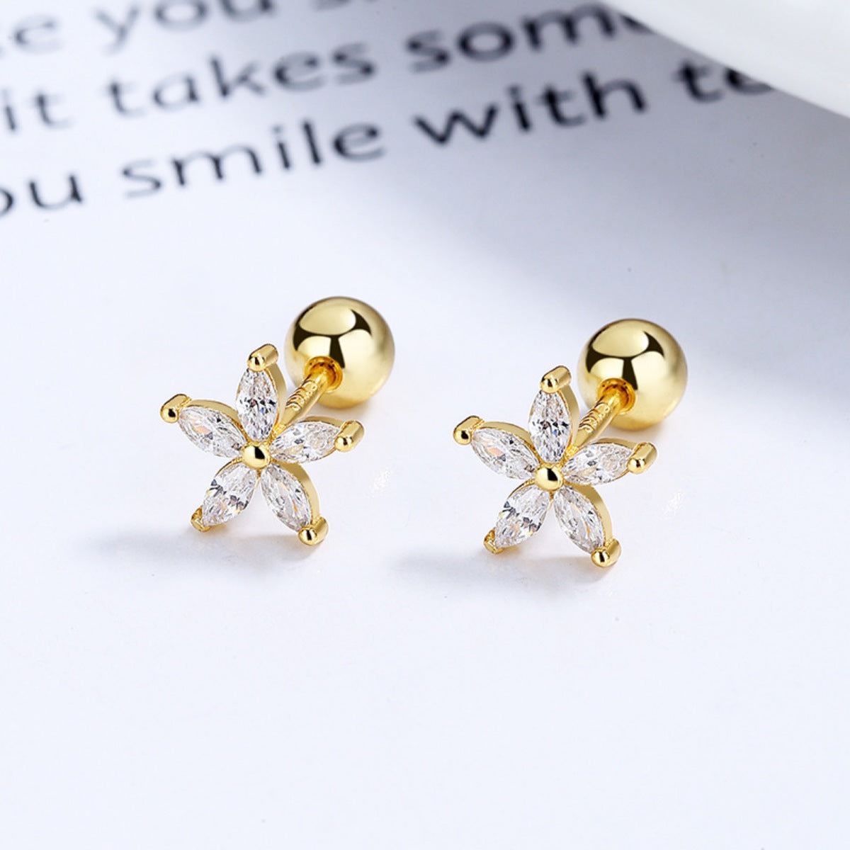 Gold flower stud earrings with clear marquise-cut stones, 925 sterling silver.