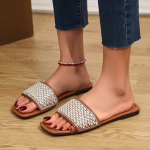 Chic open toe slide sandals with pearl and rhinestone embellishments on light brown straps.