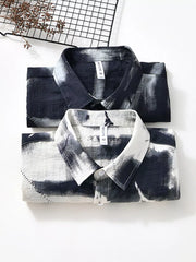 Men's abstract print button-down shirt in black and white, casual style.