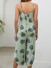 Sage Monstera print culotte jumpsuit with gathered bust and spaghetti straps.