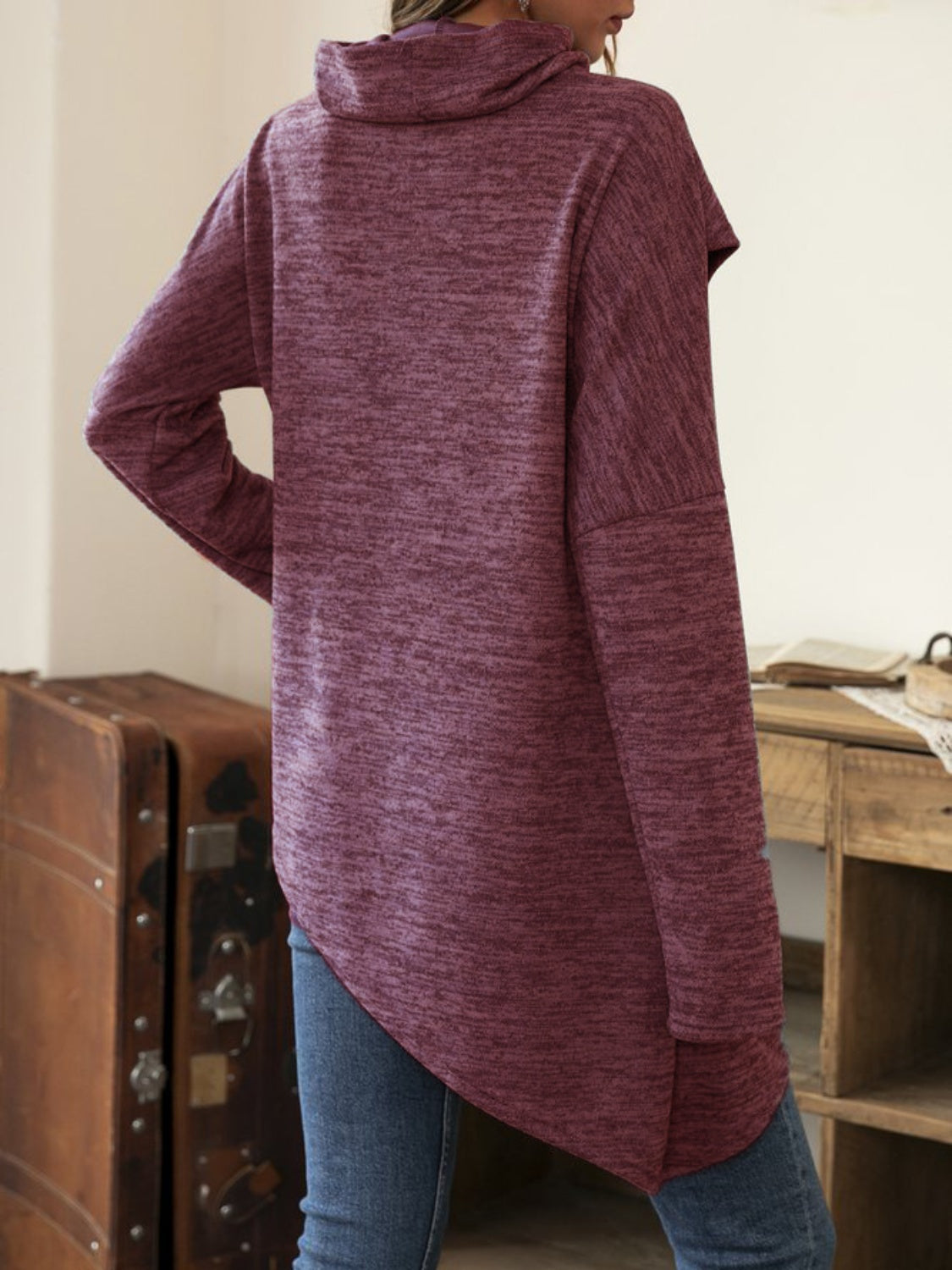Deep purple knit asymmetric top with cowl neck and long sleeves.