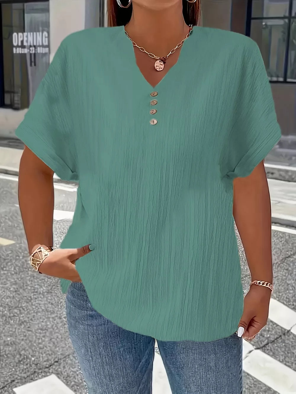 Green textured plus size V-neck t-shirt with decorative buttons and short sleeves.