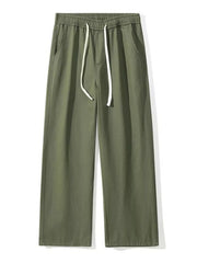 Relaxed fit military green cotton drawstring pants with elastic waistband and side pockets.