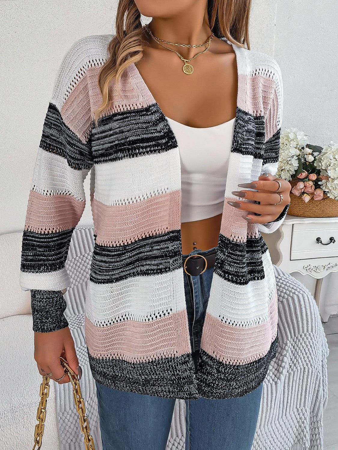 Open-front knit cardigan with horizontal stripes in blush pink, white, black, and charcoal acrylic.