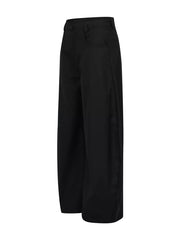 Voluminous wide-leg black sweatpants with pockets and a button closure.