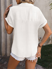 White textured linen-blend shirt with rolled short sleeves and button detail.