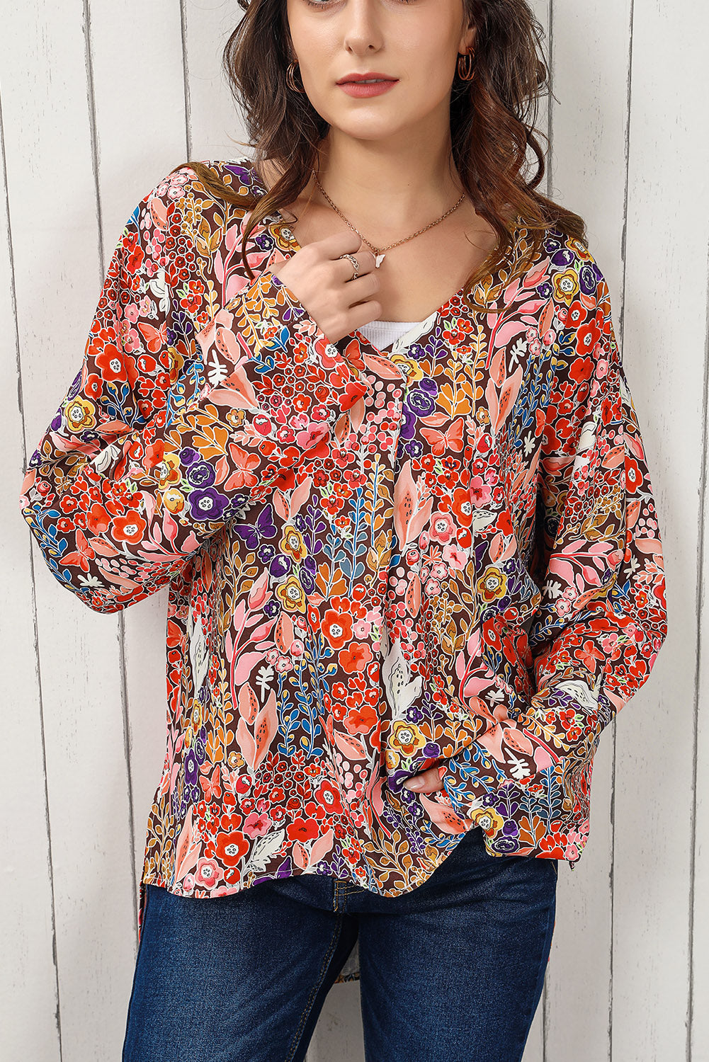 Painterly floral oversized blouse with V-neck and flared sleeves, in a colorful floral print.