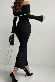 Black off-shoulder maxi dress with ruffled trim and bell sleeves.