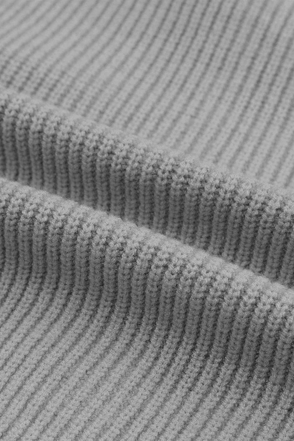 Gray ribbed knit cardigan detail showing texture and fabric.
