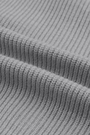 Gray ribbed knit cardigan detail showing texture and fabric.