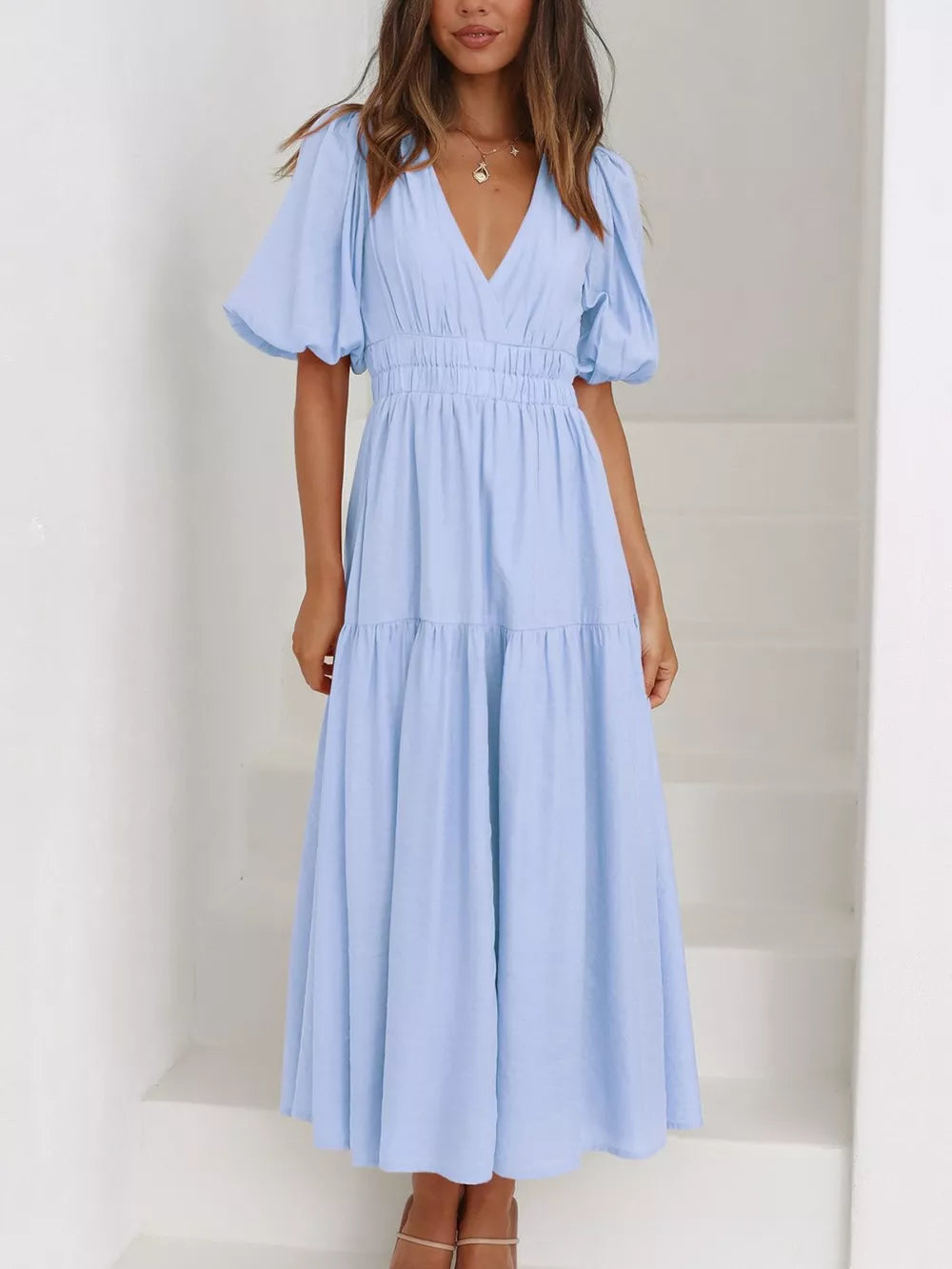 Light blue midi dress with puff sleeves, V-neck, cinched waist, and tiered skirt.