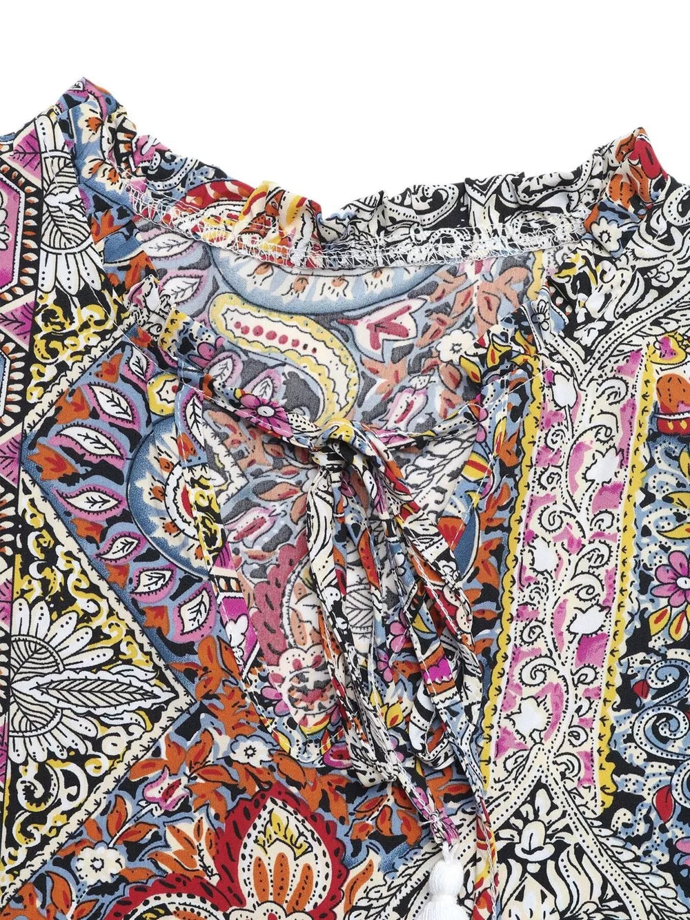 Paisley print midi dress with tie neck, ruffled collar, and decorative tassels.