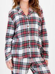 Pajama set with red, green, and white plaid pattern, button-up top and pants.