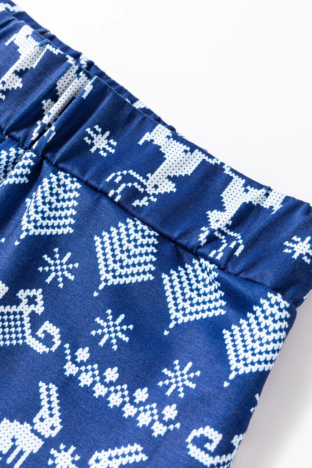 Navy loungewear set with festive white reindeer and snowflake print.