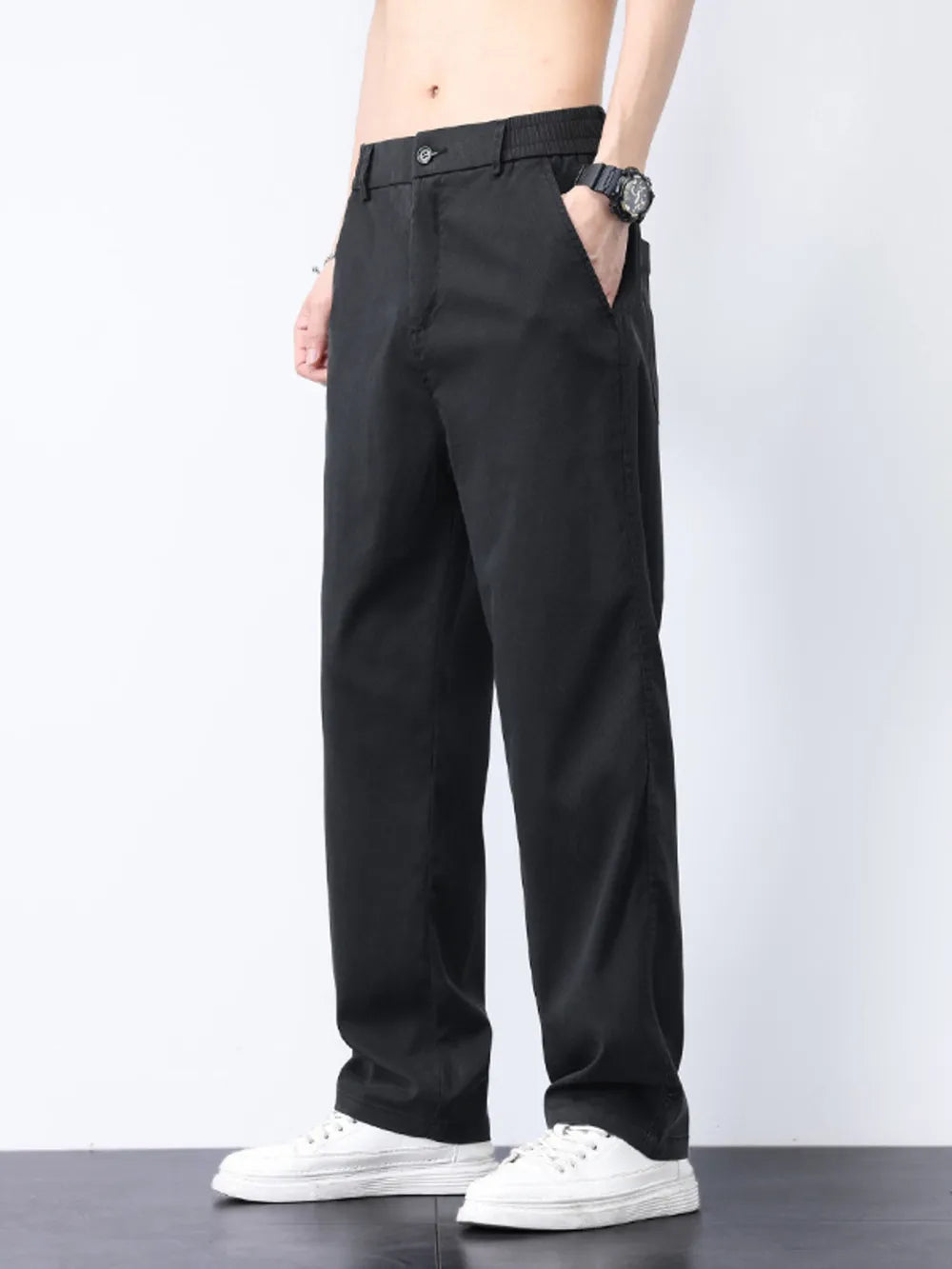 Relaxed fit black cargo pants with elastic waistband and side pockets.