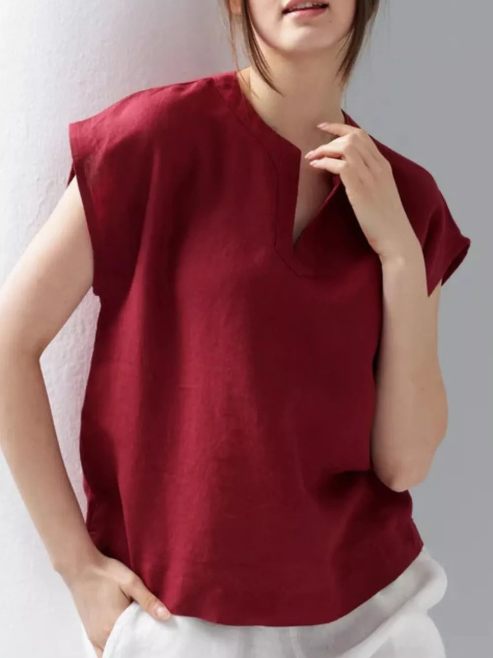 Red cap sleeve shirt with notched neckline, relaxed fit.