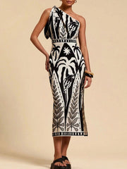 Tropical print one-shoulder midi dress in black and white with a defined waist and elegant cut.